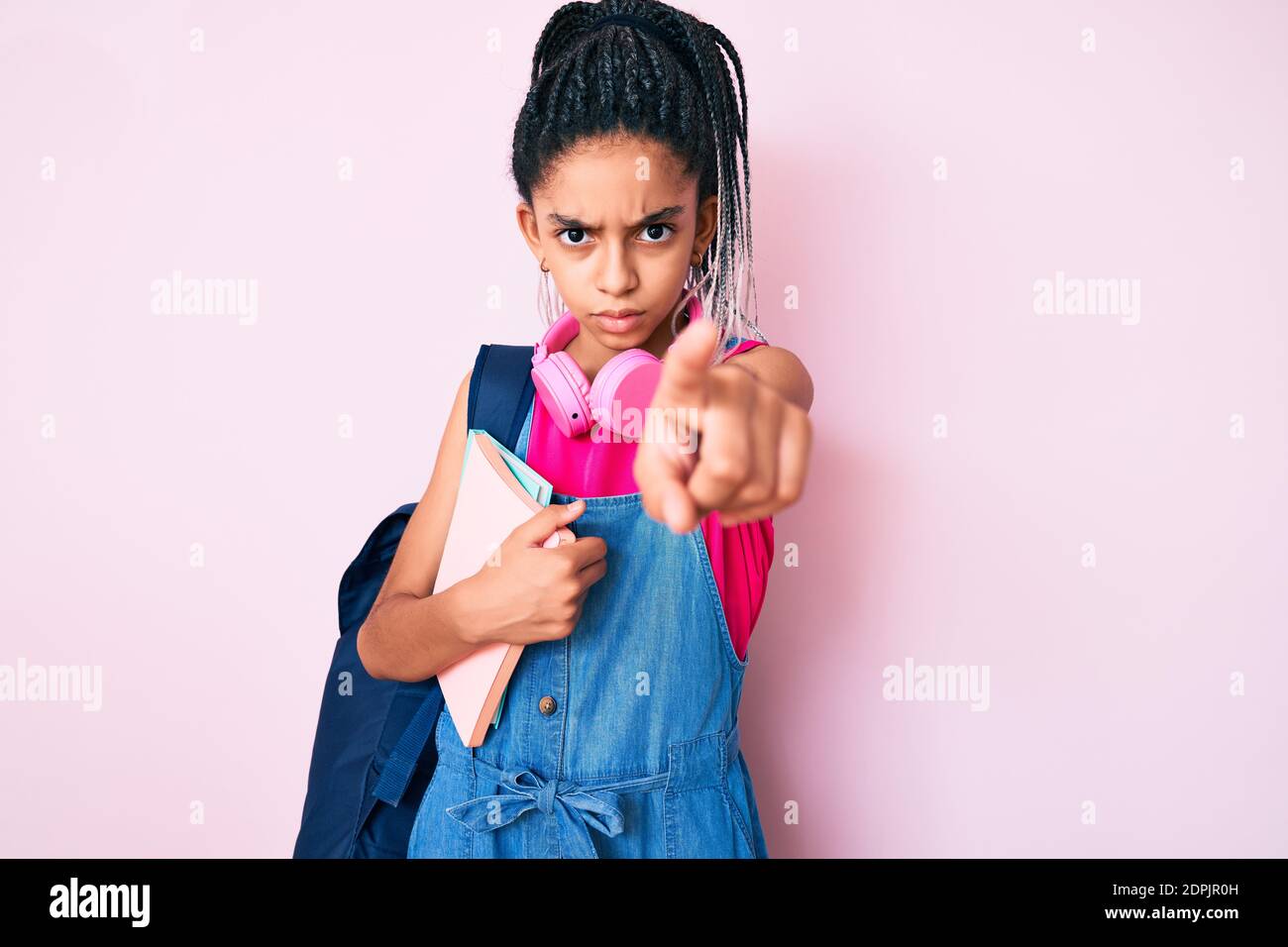 Young african american girl child with braids holding student backpack
