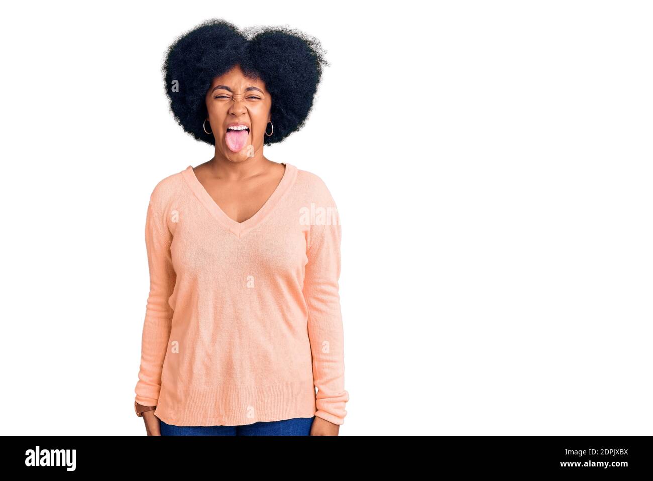 Young african american girl wearing casual clothes sticking tongue out ...