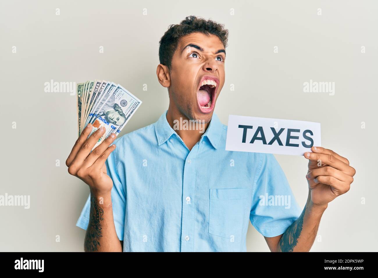 Young handsome african american man holding dollars and taxes paper