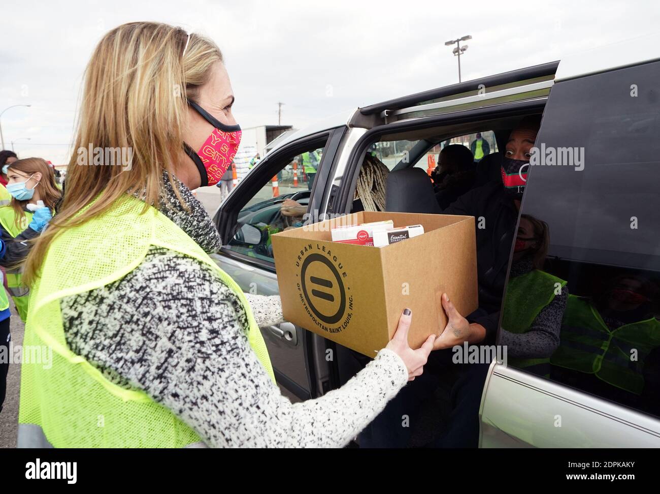 St. Louis, United States. 19th Dec, 2020. Carolyn Kindle Betz, majority owner of the St. Louis SC Major League Soccer team, hands a box of food to a recipient, during the Urban League Christmas food give-a-way in St. Louis on Saturday, December 19, 2020. Photo by Bill Greenblatt/UPI Credit: UPI/Alamy Live News Stock Photo