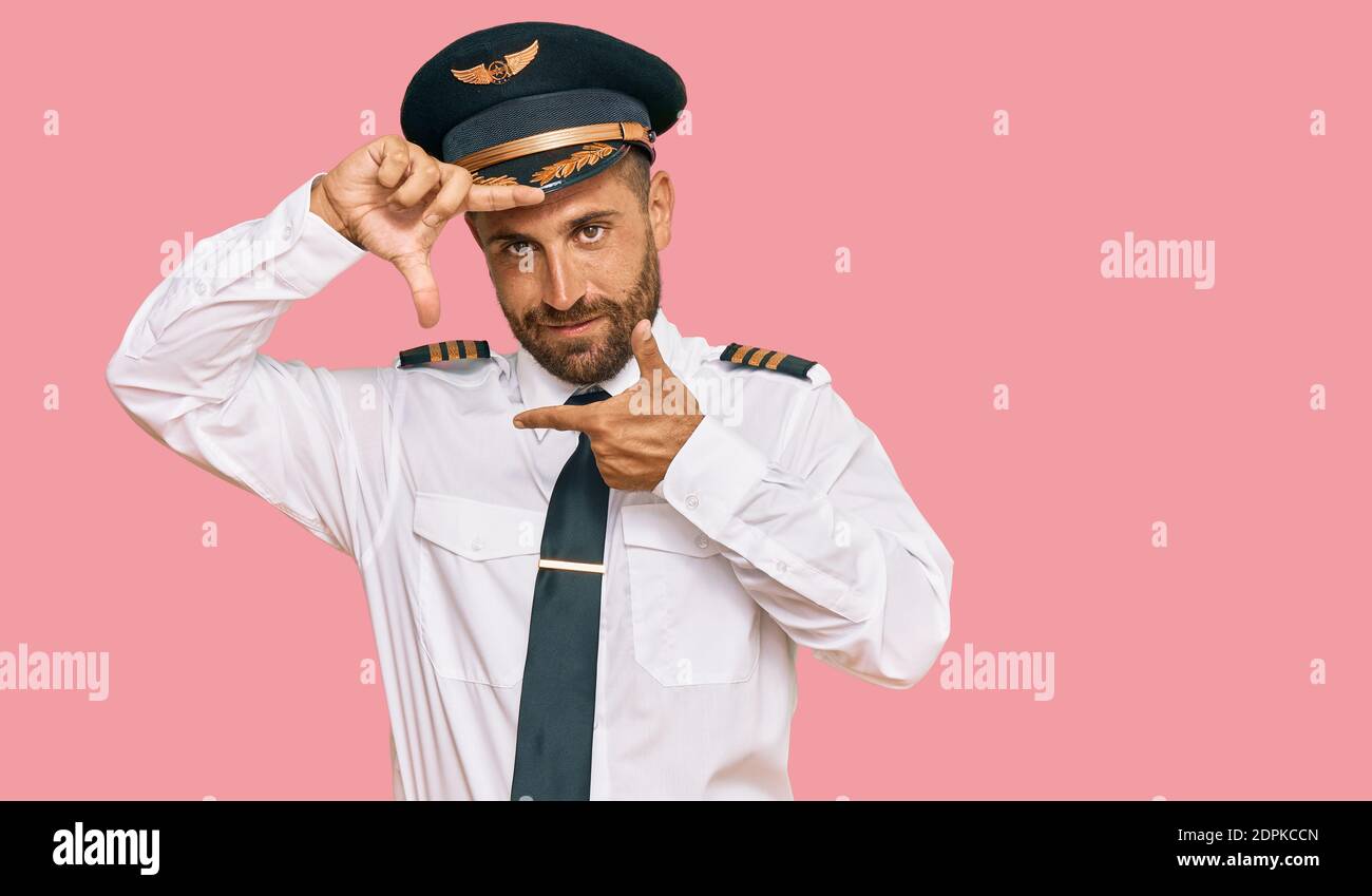 Handsome man with beard wearing airplane pilot uniform smiling making ...