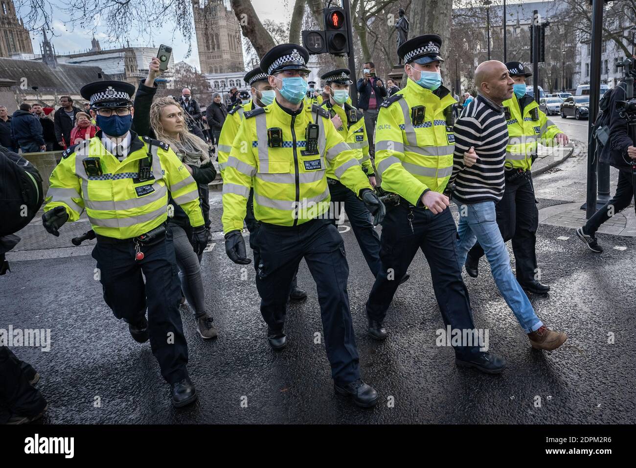 London, UK. 19th Dec, 2020. Coronavirus: Anti-lockdown ‘Unite in the Fight’ protest organised by the conspiracy group Stand Up X. Police struggle to detain activists from several hundred anti-lockdown protestors in a demonstration that came just hours before Prime Minister Boris Johnson announced increased Tier 4 measures across London and the South East of the country. Several arrests are made by Met police. Credit: Guy Corbishley/Alamy Live News Stock Photo