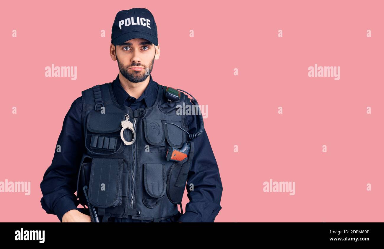 Young handsome man with beard wearing police uniform depressed and worry for distress, crying angry and afraid. sad expression. Stock Photo