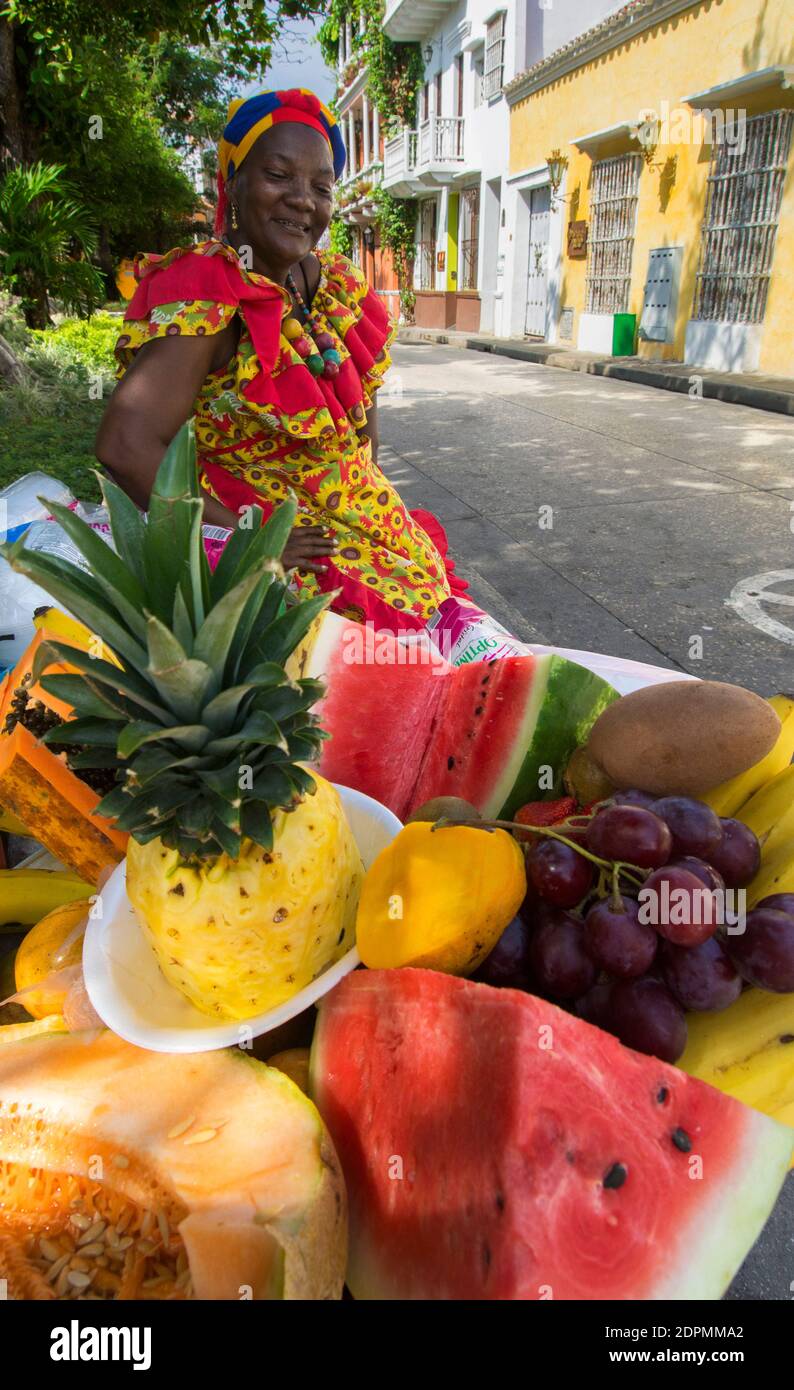 A fruit vendor, or Palenquera, in the streets of Cartagena Stock Photo