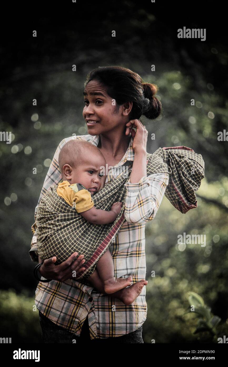 Indian woman carrying baby on hi-res stock photography and images - Alamy