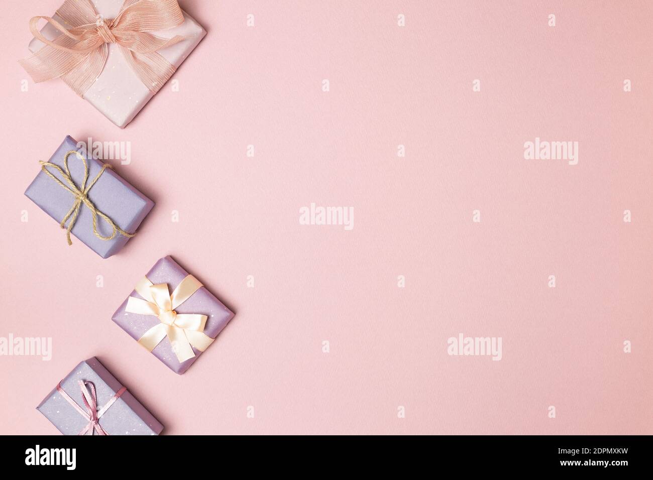 Pastel pink and purple gift boxes on pink background. flat lay, top ...