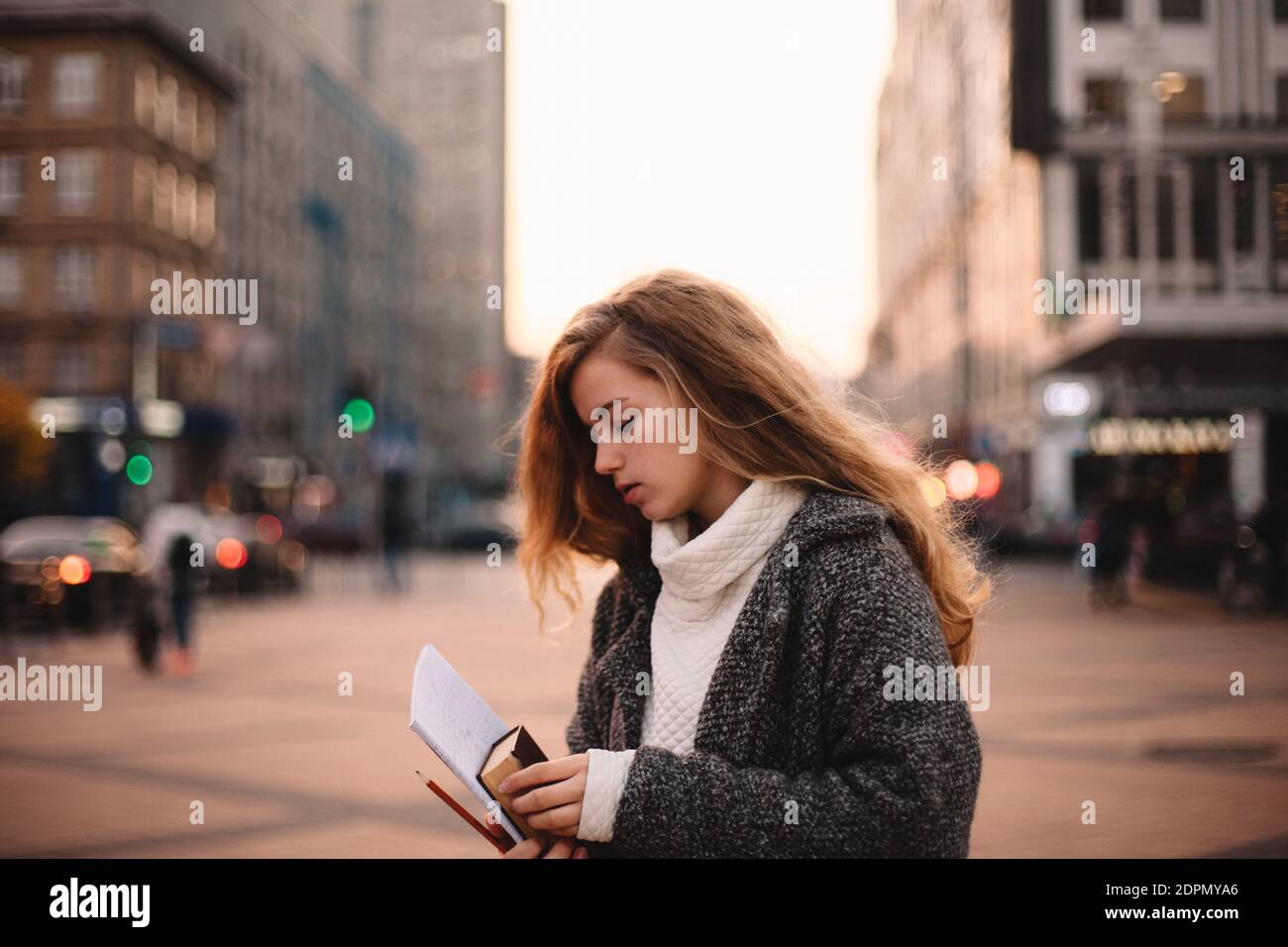 Portrait of cute teenage student girl standing in city Stock Photo - Alamy