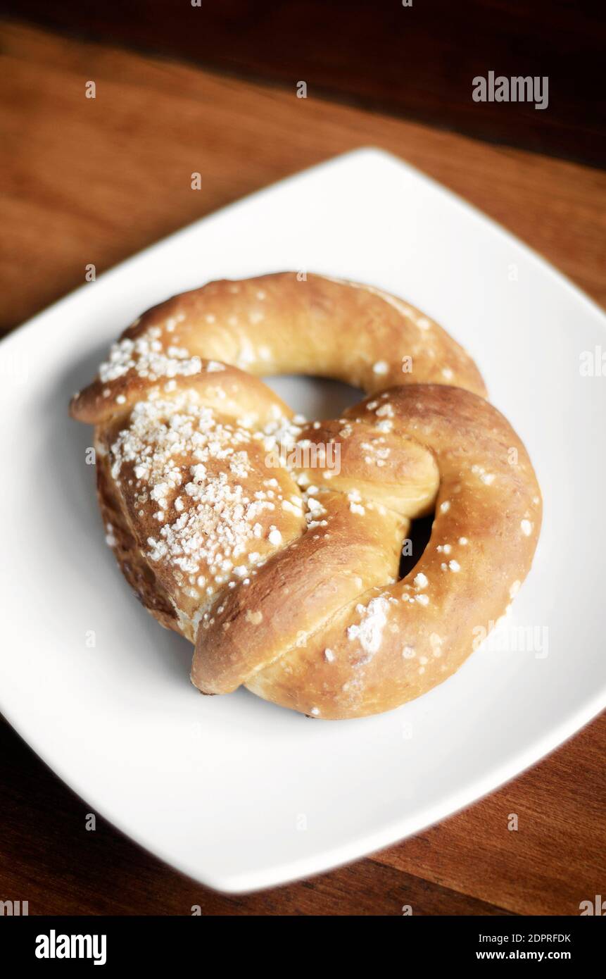 vegan dairy-free organic german traditional pretzel bread on wood table Stock Photo