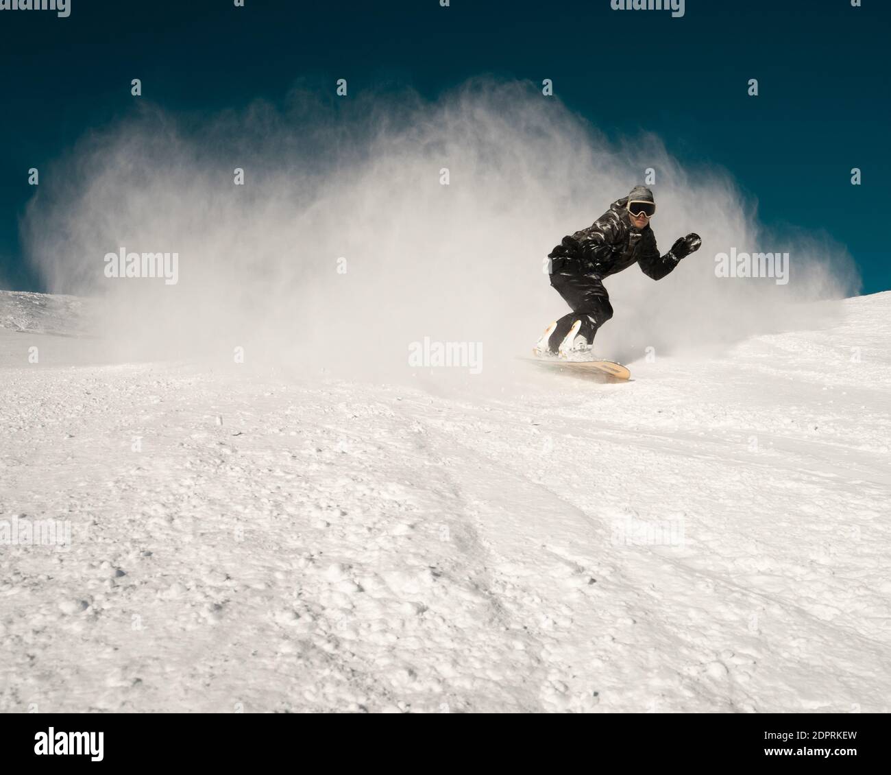 Man Snowboarding On Snowy Land Against Clear Sky Stock Photo - Alamy