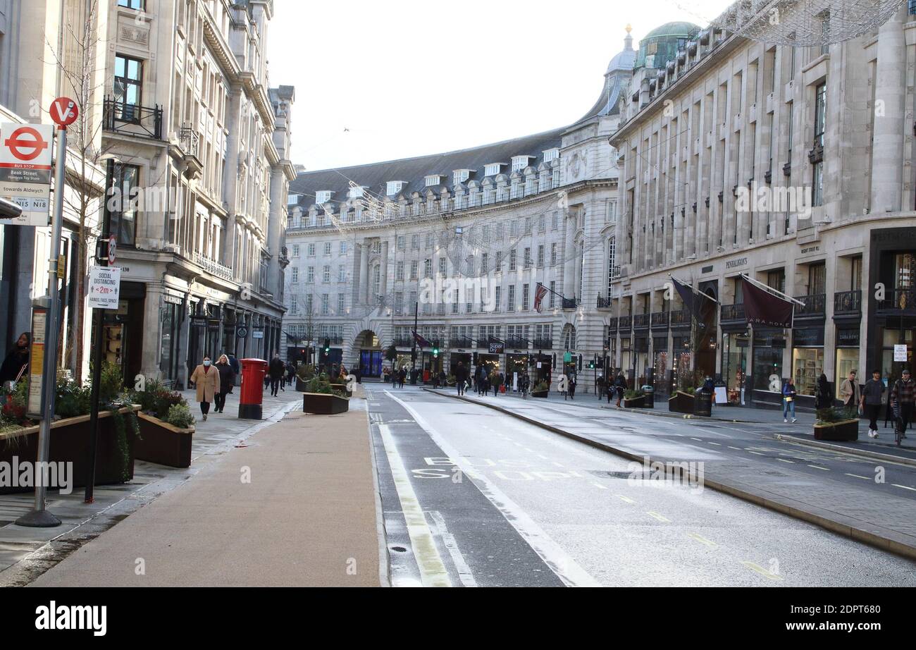 Only a handful of people in Regent Street despite it being closed to traffic.London enters Tier 4 severe restrictions as new Mutant Covid-19 strain is found. The new variant of the virus has been found to be 70% more infectious and is currently rampant throughout London and the South East of England. Stock Photo