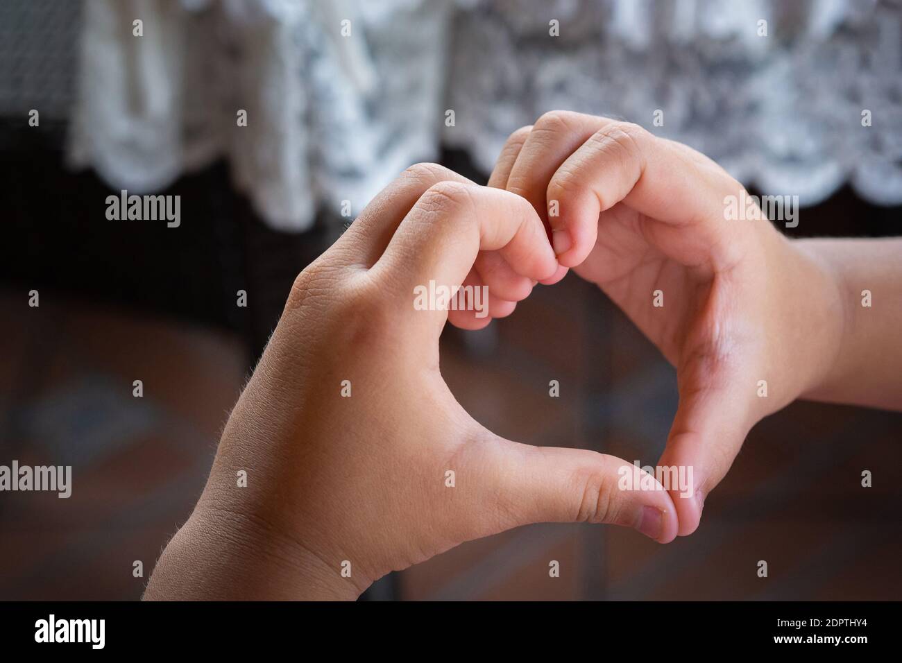 Close Up Photo Of Hands A Child Making Fingers Showing As A Heart Symbol To Say That I Love You Stock Photo Alamy