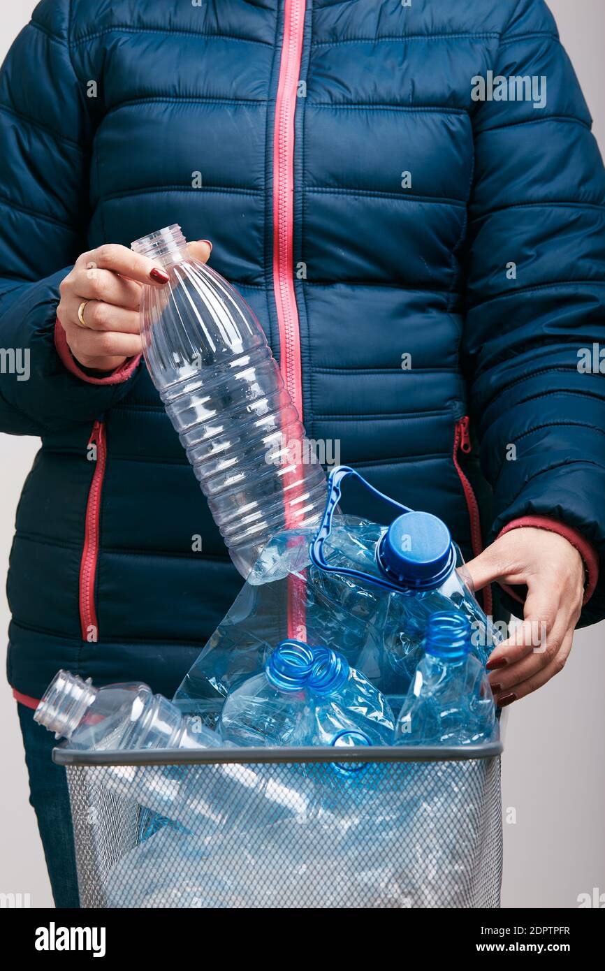 Midsection Of Woman Throwing Plastic Bottles In Bin Stock Photo Alamy