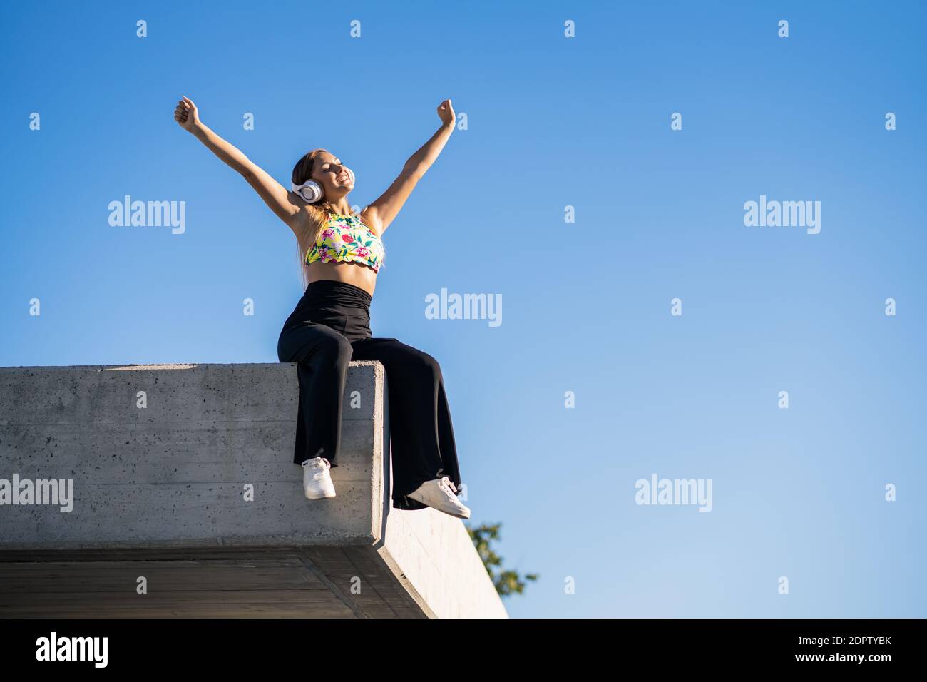 Girl sitting on wall low angle hi-res stock photography and images - Alamy