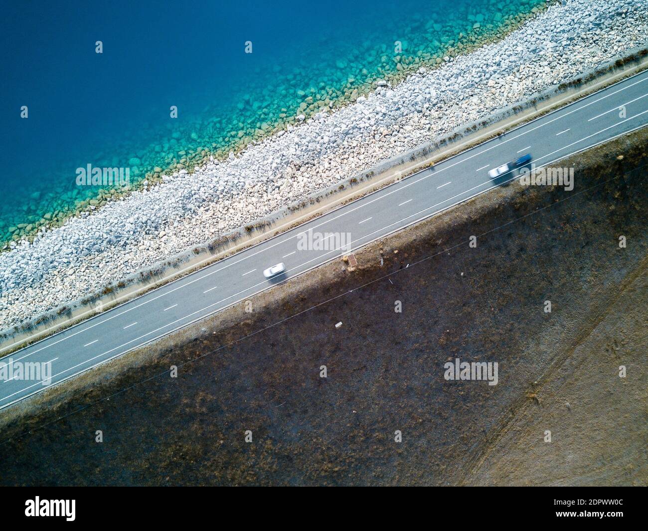 Aerial View Of Cars On Road By Sea Stock Photo