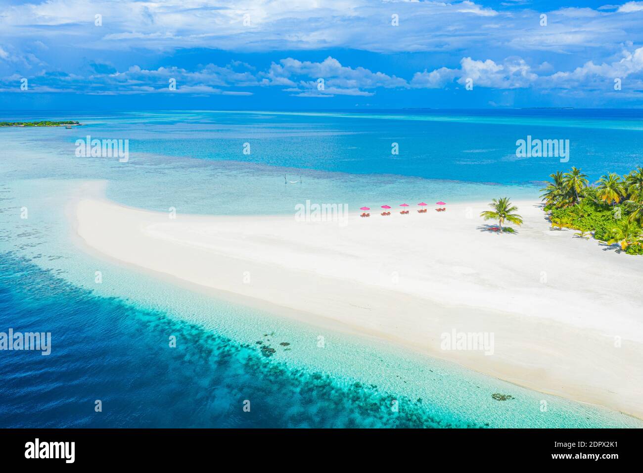 Aerial photo of beautiful Maldives paradise tropical beach. Amazing view, blue turquoise lagoon water, palm trees and white sandy beach. Luxury travel Stock Photo