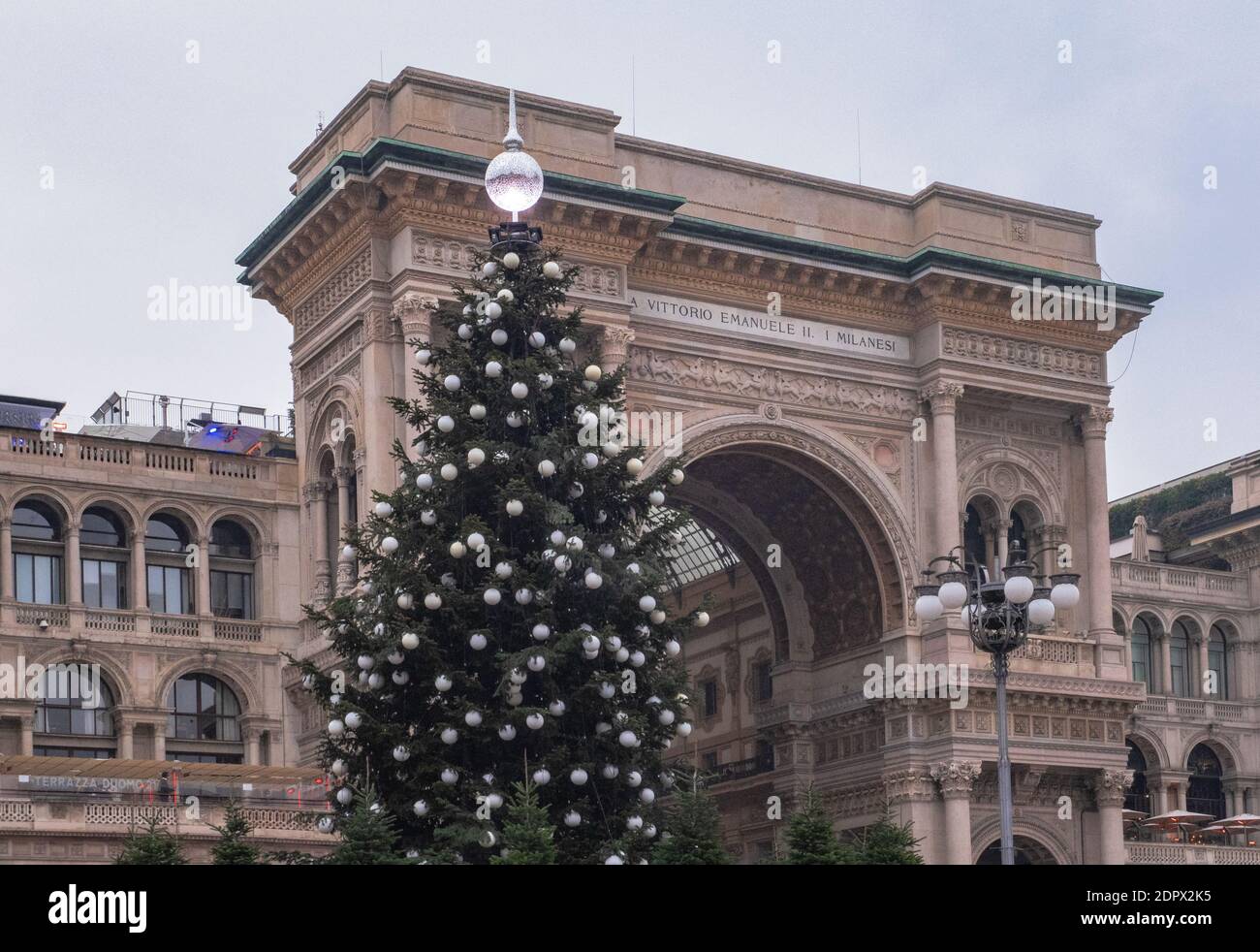 entrance into the Vittorio Emanuele gallery decorated with a large Christmas tree. Duomo Square, Milan, Italy Stock Photo