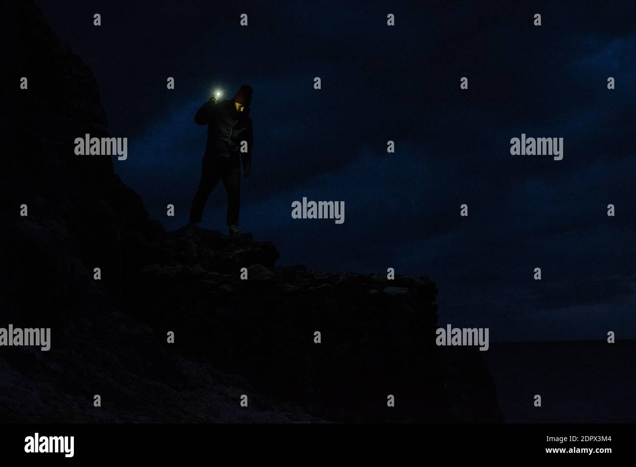 Man standing on cliff night hi-res stock photography and images - Alamy