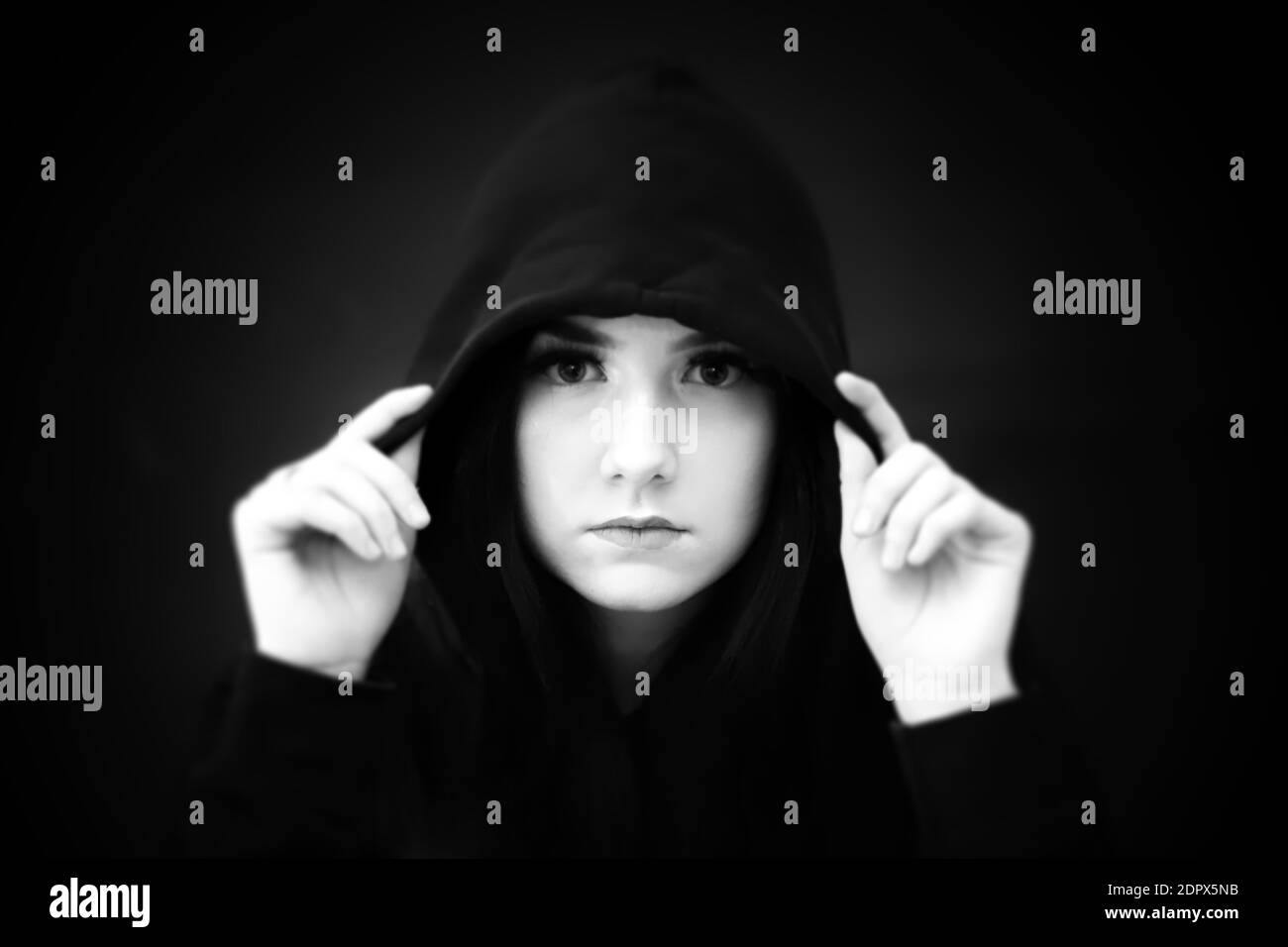 Close-up Portrait Of Teenage Girl Wearing Hood Against Black Background ...
