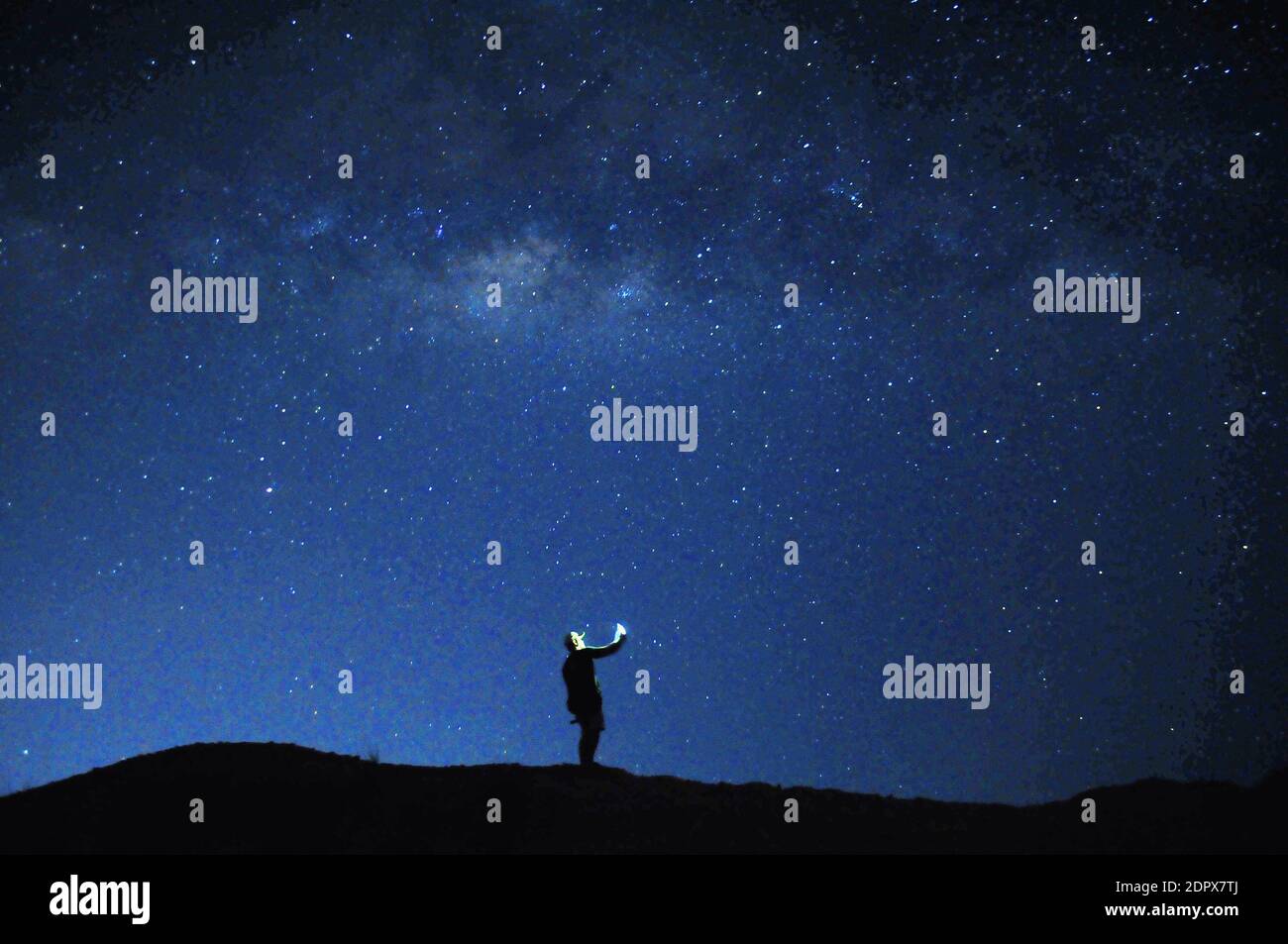Silhouette Man Standing On Land Against Sky At Night Stock Photo