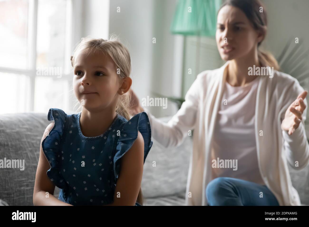 Close up angry strict mother scolding stubborn naughty daughter Stock Photo