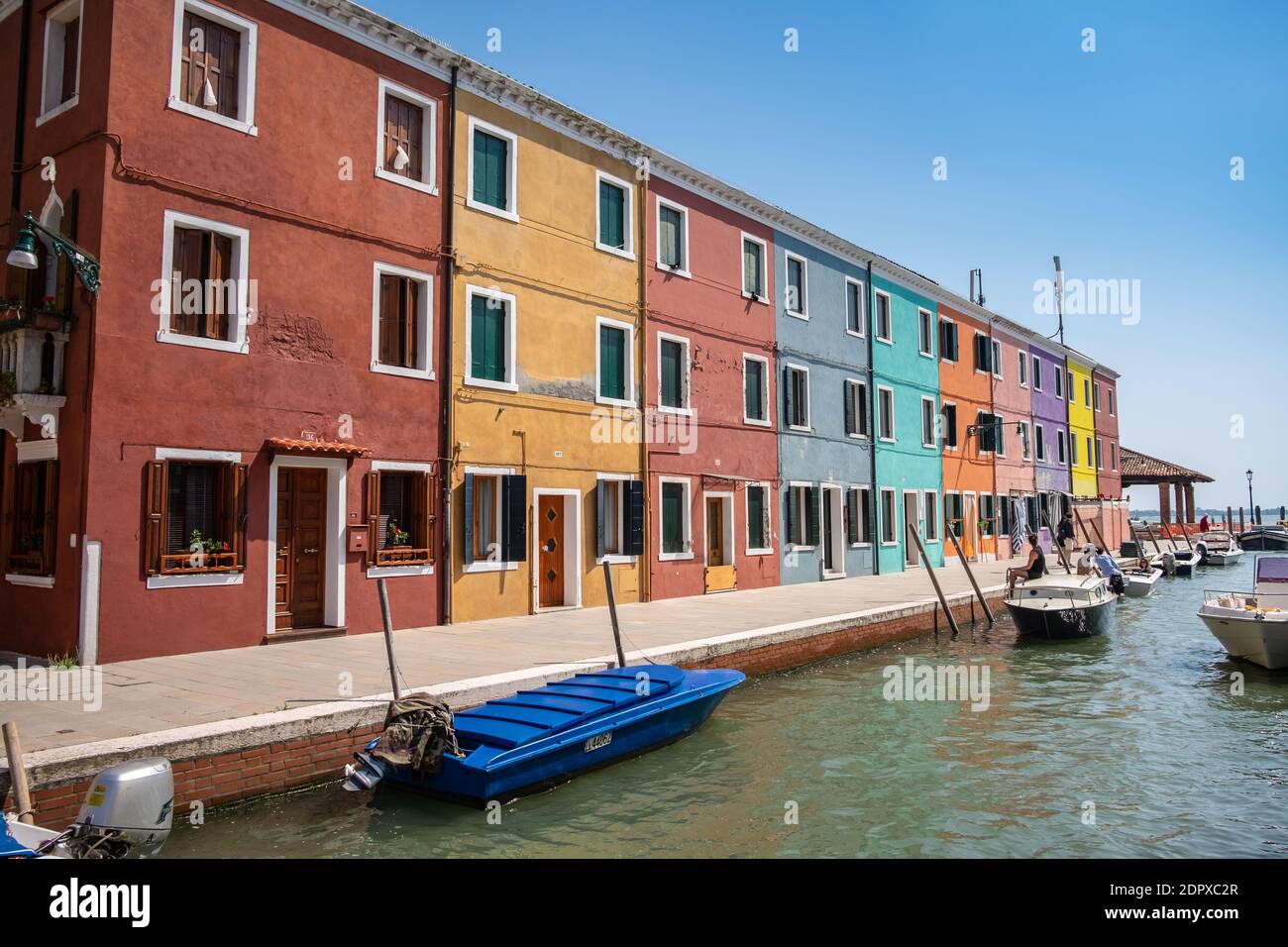Venice landmark, Burano island canal, colorful houses and boats Stock Photo