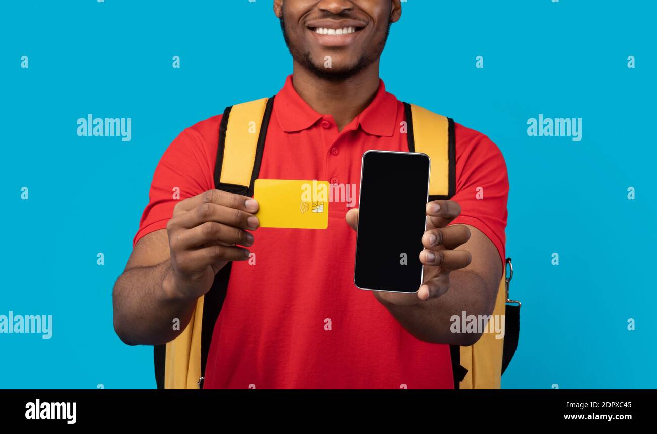 African american courier showing credit card and mobile phone Stock Photo