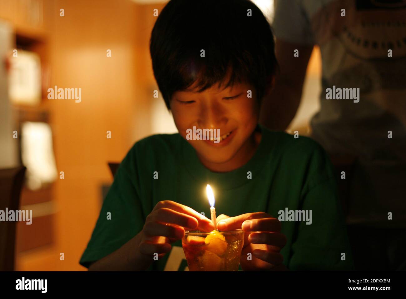 Smiling Teenage Boy With Burning Candle At Home Stock Photo Alamy