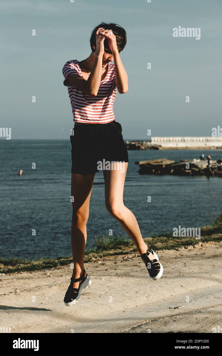 Woman dancing beach jeans hi-res stock photography and images - Alamy