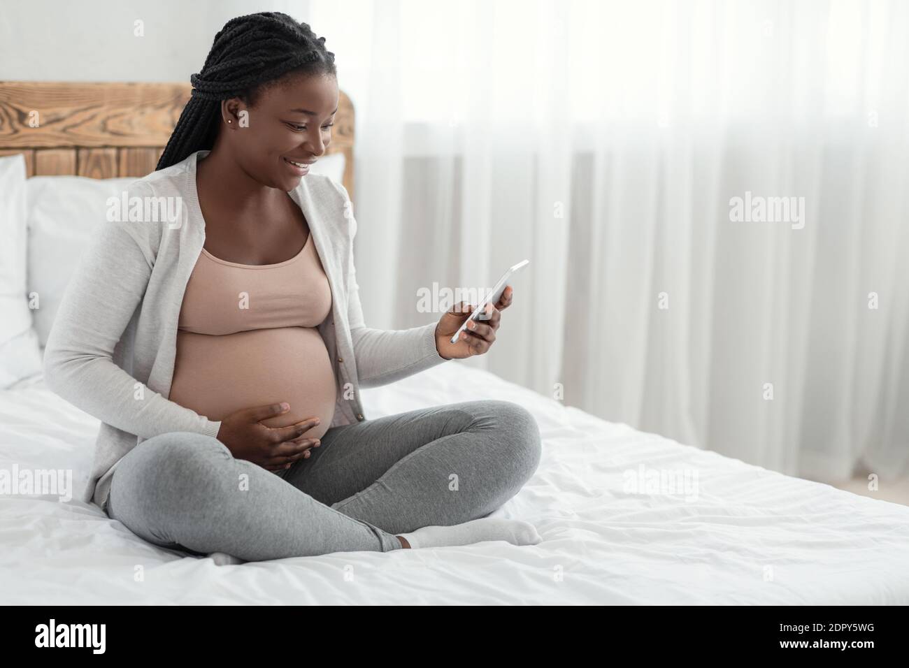 Excited black woman browsing hi-res stock photography and images - Alamy