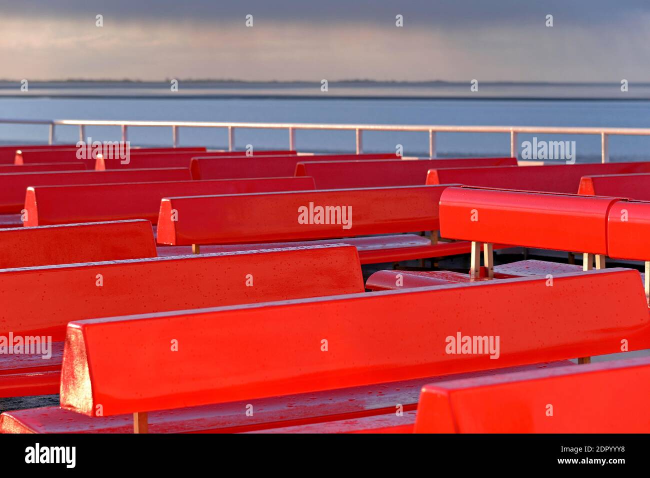 Ferry, outer deck with red benches, approaching rain front, North Sea, North Sea coast, Norddeich, Lower Saxony, Germany Stock Photo