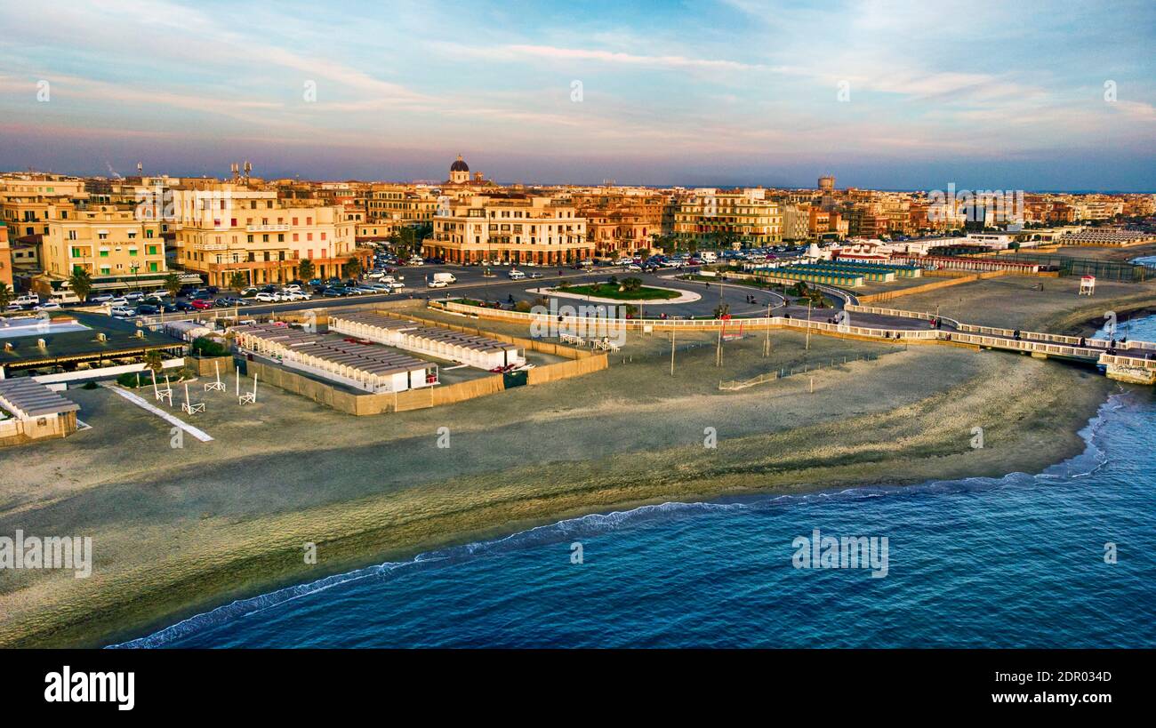 Sunset Rome aerial view in Ostia Lido beach over blue sea with city skyline and view of Ravennati square and pedestrian pier a landmark of tourist and Stock Photo