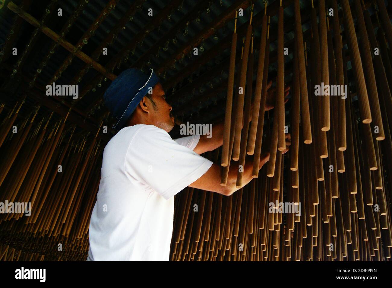 Low Angle View Of Man By Incense Sticks Stock Photo