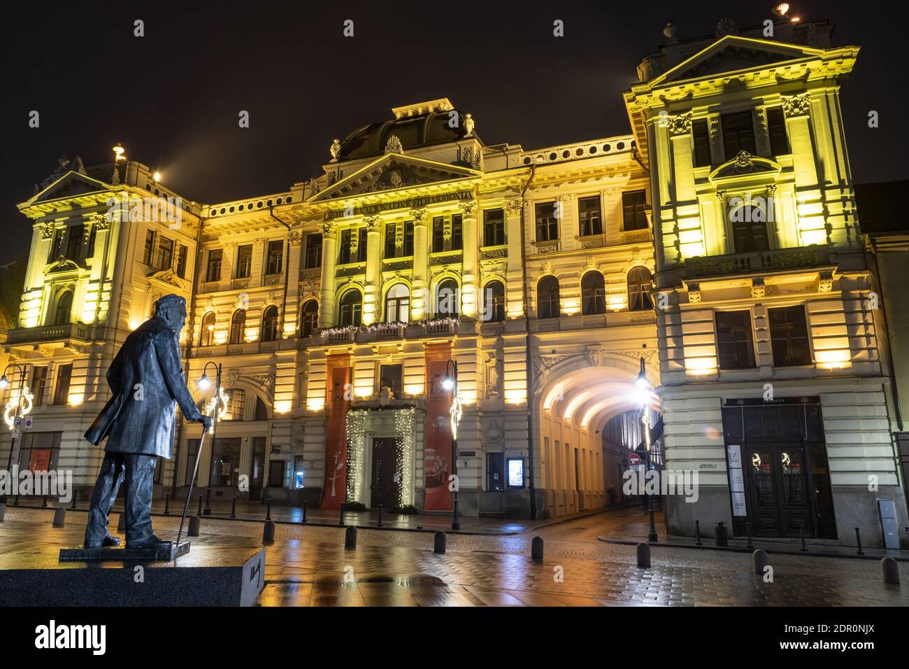 Lithuanian National Philharmonic in Vilnius, night view with monument for Jonas Basanavičius Stock Photo