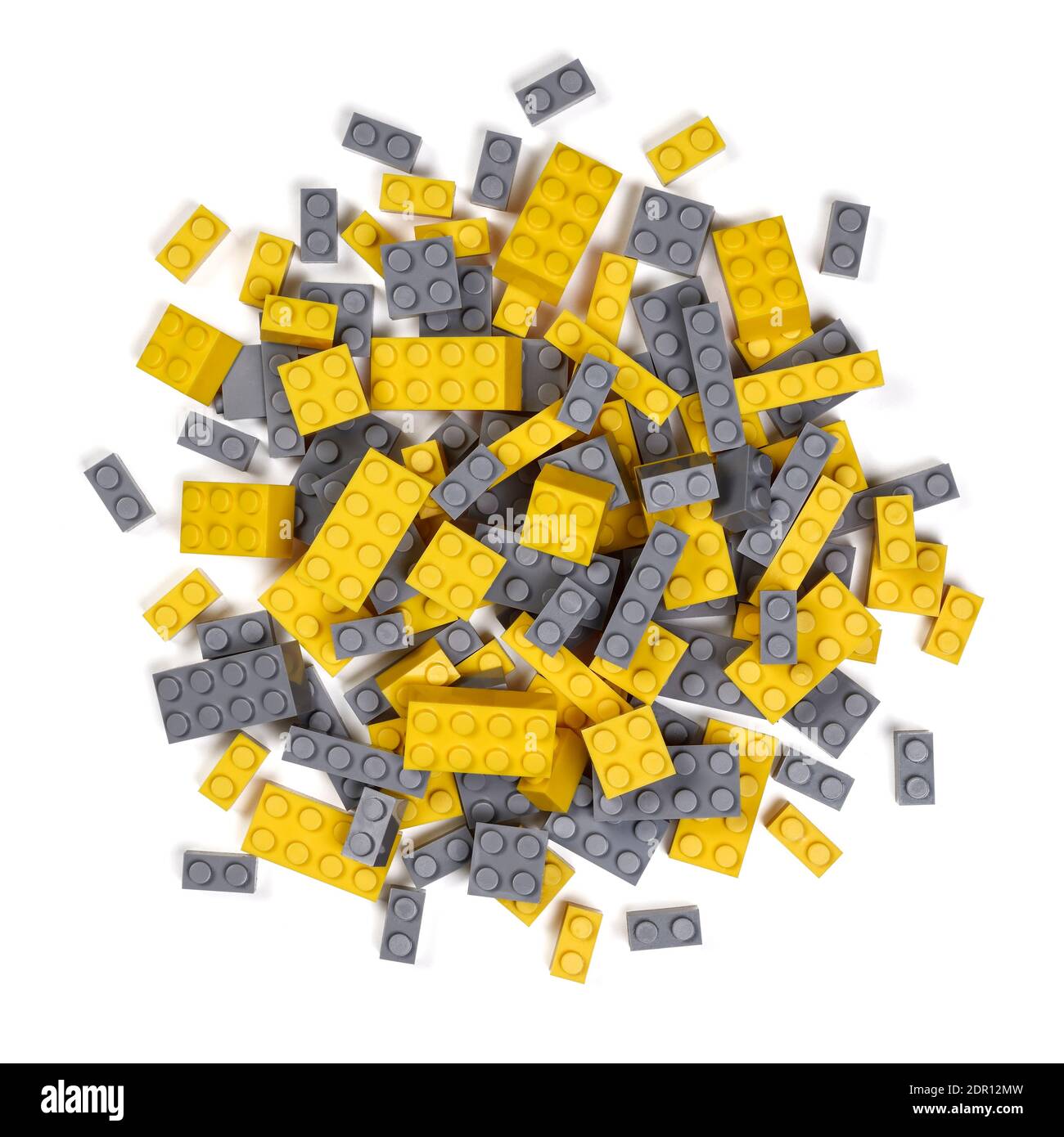 Overhead pile of plastic toy bricks in the Pantone colour of the year 2021 grey and yellow Stock Photo