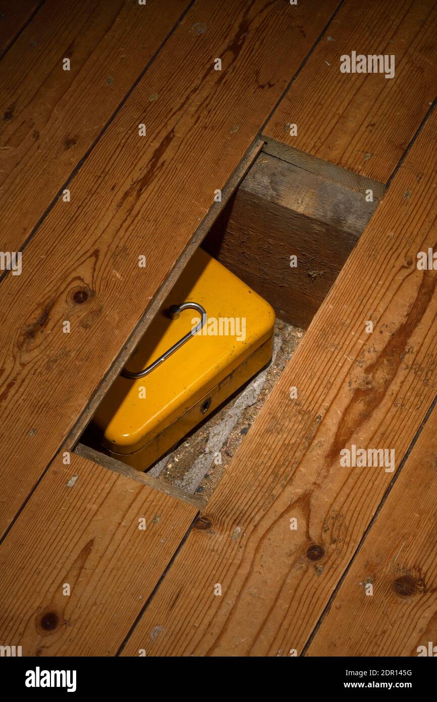 A metal box hidden under floorboards Stock Photo