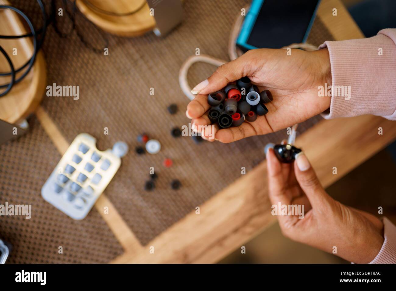 Woman choosing ear pads in audio store Stock Photo