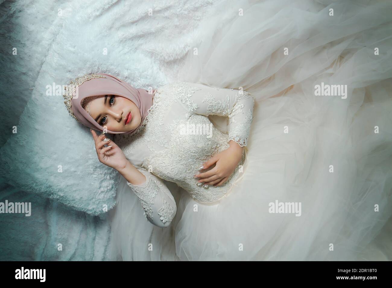 Asian Muslim Bride In White Wedding Gown With Hijab Or Jilbab ...