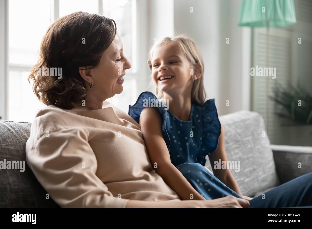 Close up happy mature woman with little girl talking Stock Photo