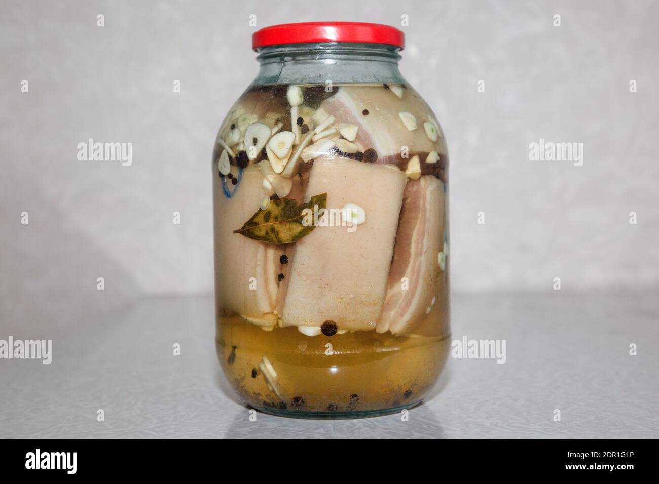 Salted lard in brine in jar with spices Stock Photo Alamy