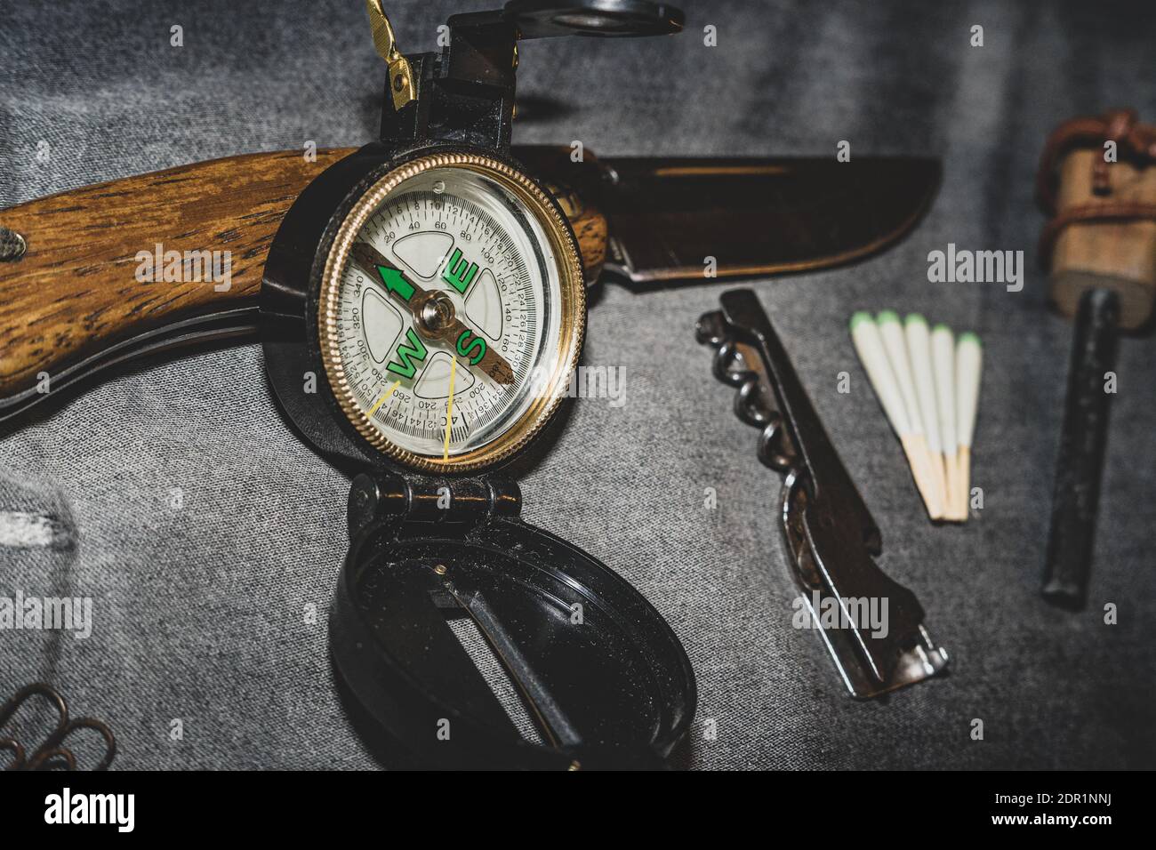 Compass, knife and matches. EDC. Wearable set for survival and tourism