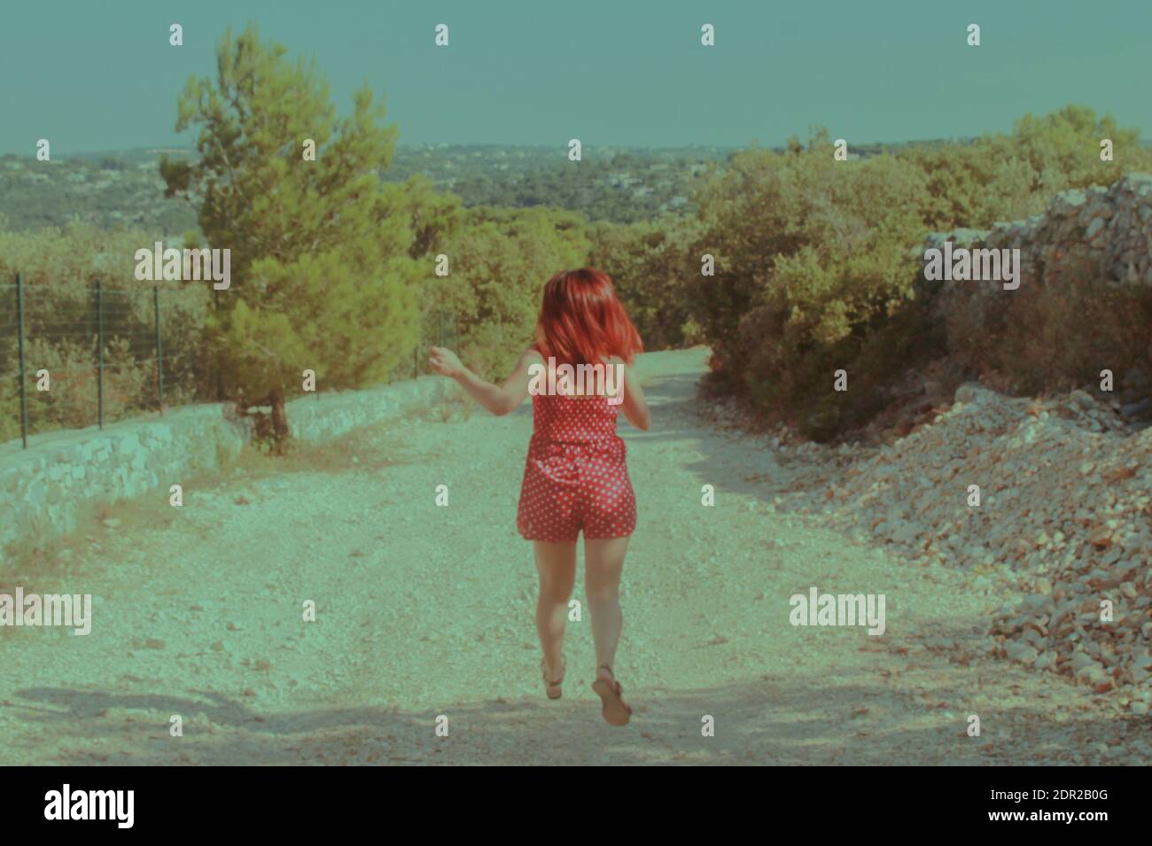 Rear View Of Young Woman Running On Dirt Road Stock Photo Alamy
