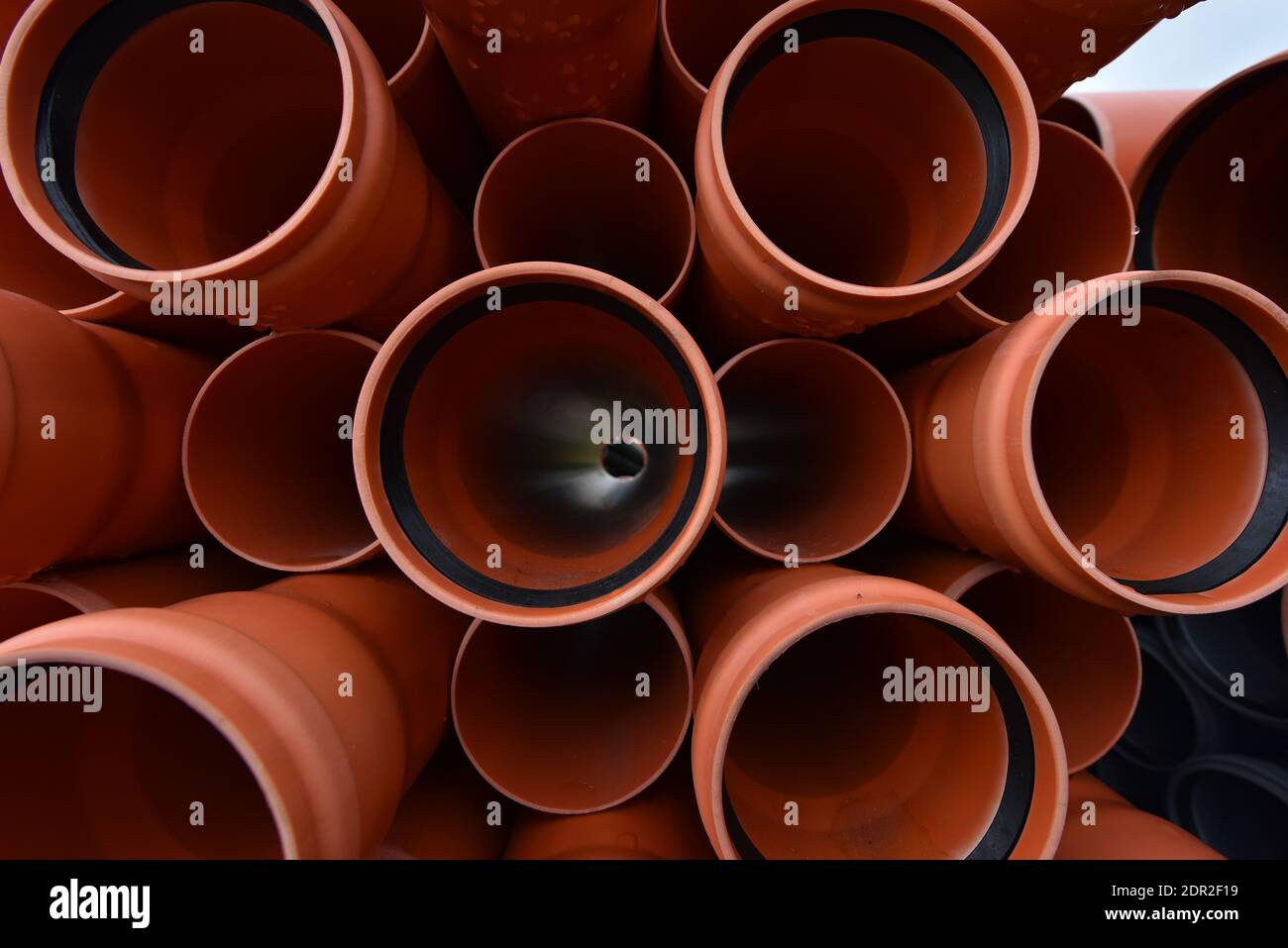 Large orange plastic pipes for sewerage system. Stock Photo