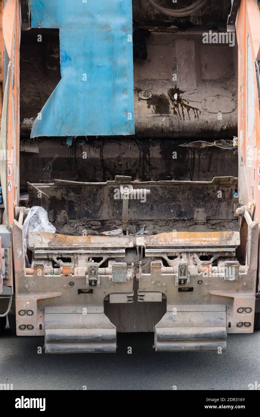 Rear view of a dirty garbage or waste disposal vehicle Stock Photo