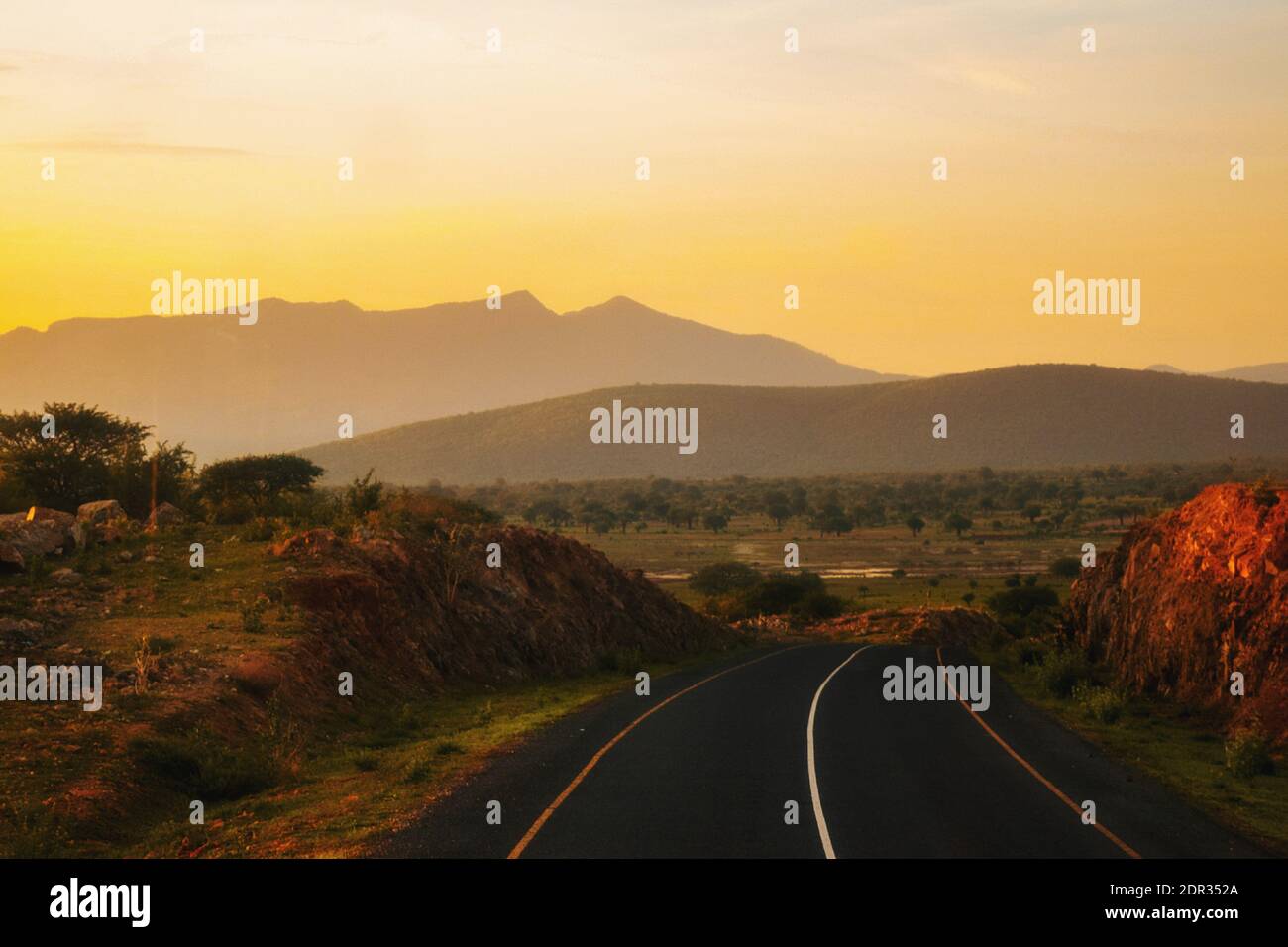 An Empty Highway Against A Golden Sunset At Iringa, Tanzania Stock Photo