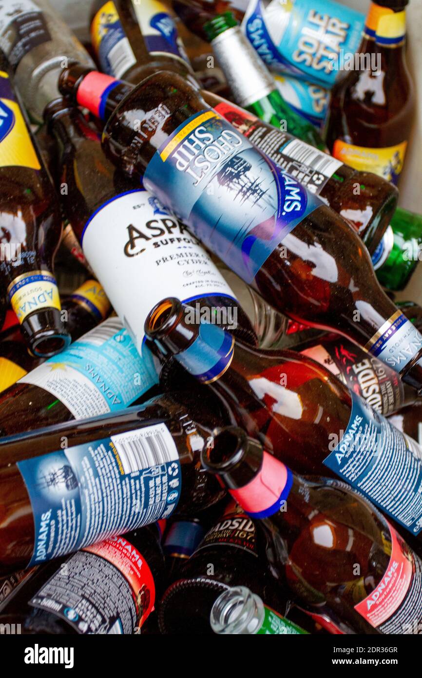 Heaped empty beer and cider bottles in a bin Stock Photo