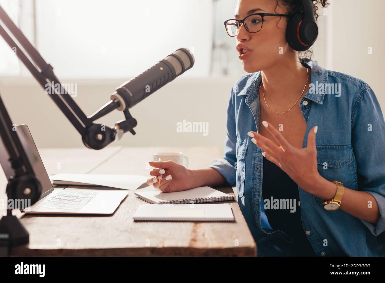 Young woman recording and broadcasting her podcast from home. Female  working from home and running her radio show Stock Photo - Alamy