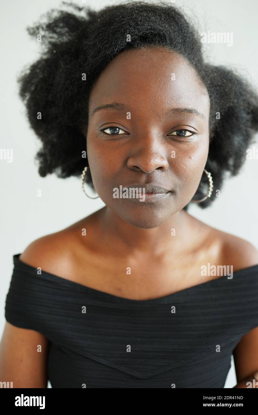 portrait of confident young black woman intern looking serious at ...