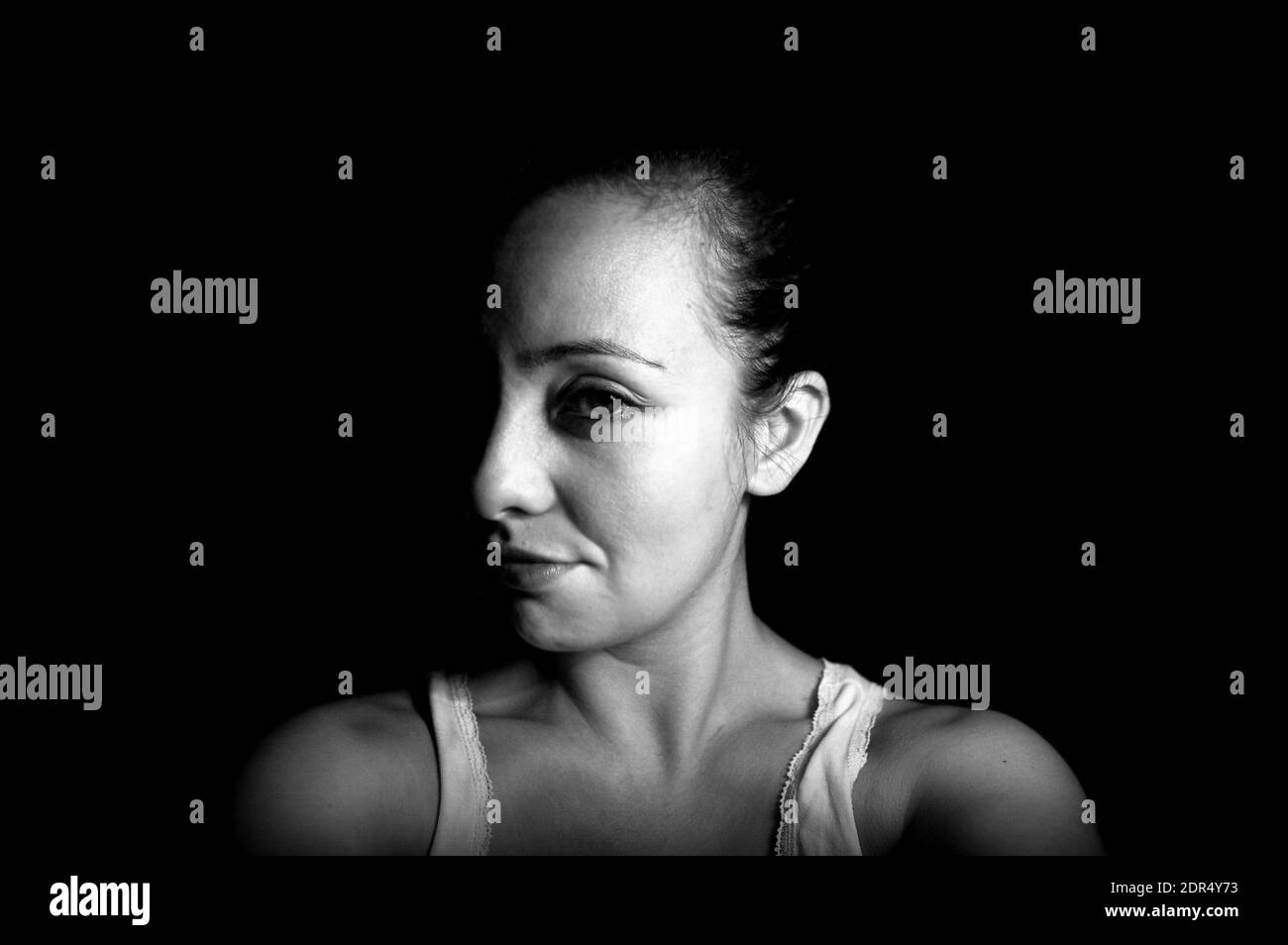 Portrait Of Woman Against Black Background Stock Photo - Alamy