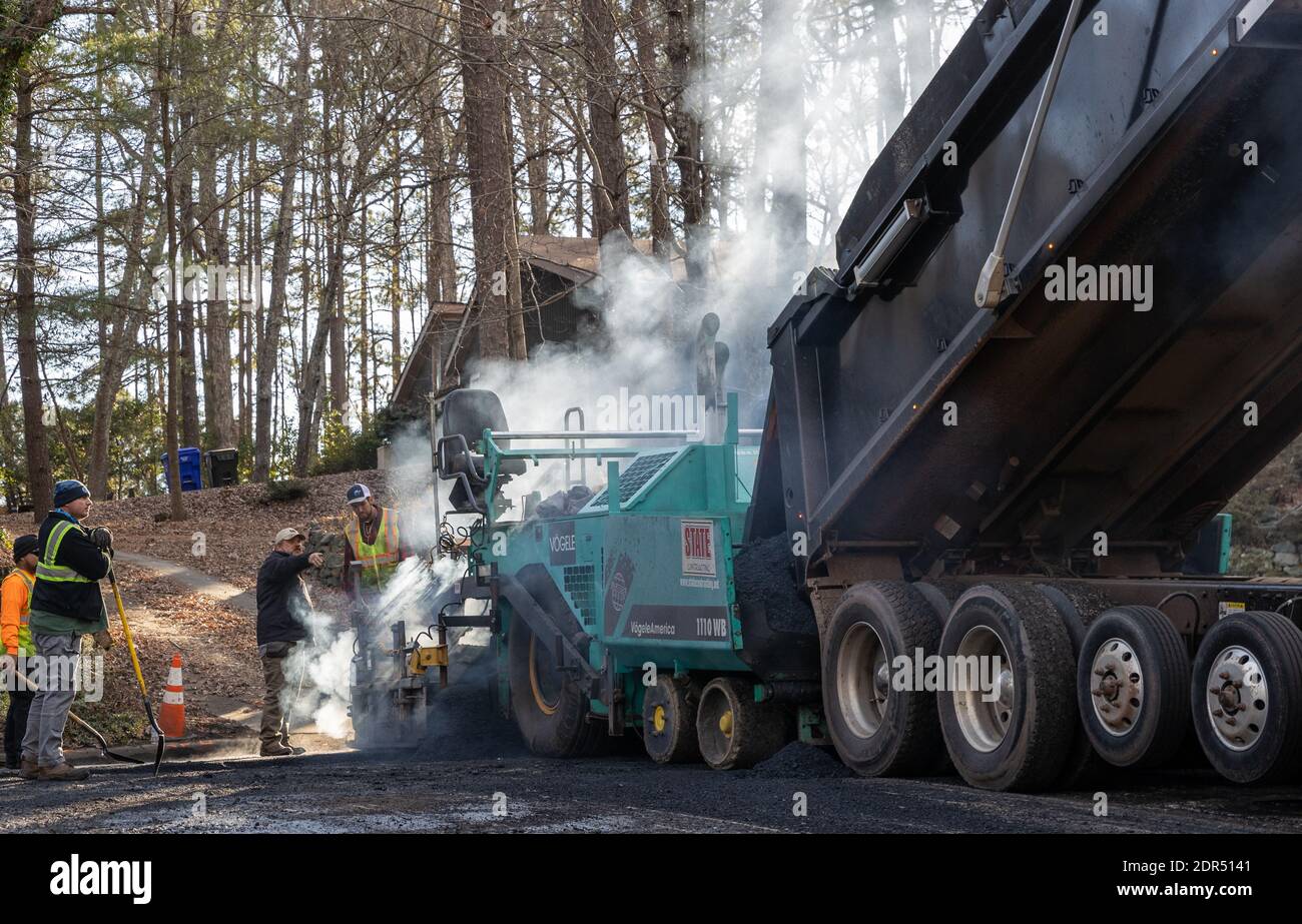 Steam billow from asphalt road paver on a winter day Stock Photo