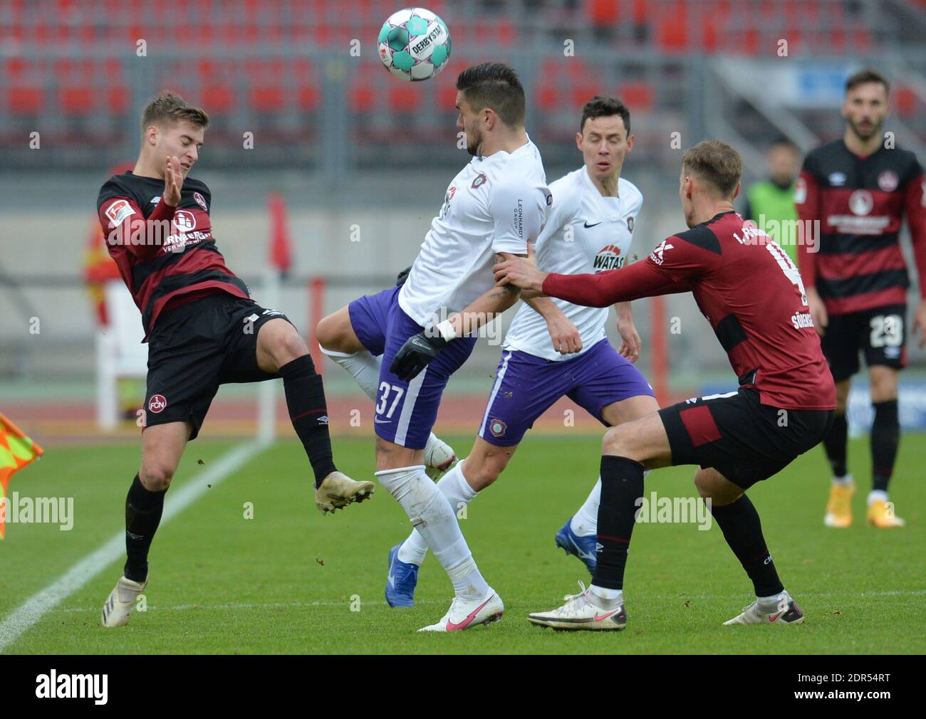 Nuremberg, Germany. 20th Dec, 2020. Soccer: 2. Bundesliga, 1. FC Nürnberg - Erzgebirge Aue, Matchday 13, Max-Morlock-Stadion Nuremberg: Pascal Testroet (M) from Aue plays against Fabian Nürnberger (l) and Asger Sörensen (r) from Nuremberg. Credit: Timm Schamberger/dpa - IMPORTANT NOTE: In accordance with the regulations of the DFL Deutsche Fußball Liga and/or the DFB Deutscher Fußball-Bund, it is prohibited to use or have used photographs taken in the stadium and/or of the match in the form of sequence pictures and/or video-like photo series./dpa/Alamy Live News Stock Photo